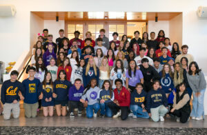 The Class of 2023 pose in their college sweatshirts