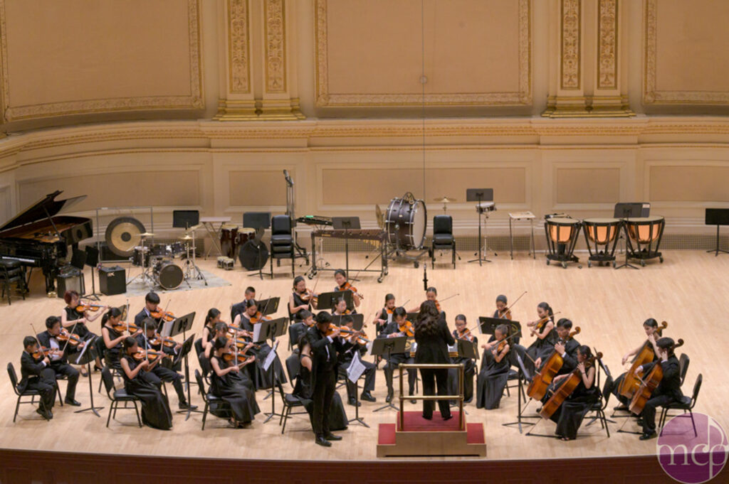 Eric Gu '26 playing the solo of "The Butterfly Lovers" on stage at Carnegie Hall