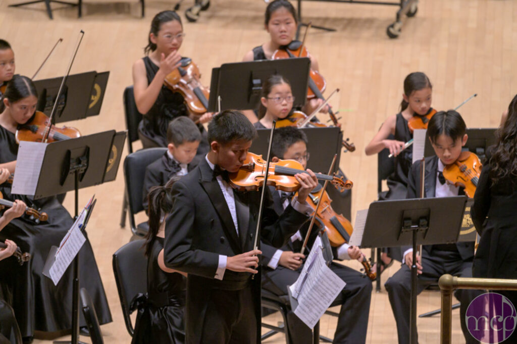 Eric Gu '26 playing the solo of "The Butterfly Lovers" on stage at Carnegie Hall