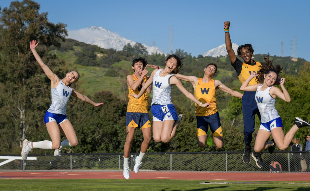 Webb Track Team jumping in front of Snowy Mountains